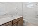 Modern bathroom features a shower-tub combo, wood cabinets, and quartz counters at 304 White Oak Garden Way # 214, Garner, NC 27529