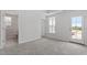 Carpeted bedroom with a door to the bathroom and an exterior entrance at 304 White Oak Garden Way # 214, Garner, NC 27529