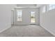 Bright bedroom with carpet, tray ceiling, doors, and windows at 304 White Oak Garden Way # 214, Garner, NC 27529