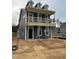 New construction home featuring Hardie siding, three dormers and a covered porch on a lot prepped for landscaping at 304 White Oak Garden Way # 214, Garner, NC 27529