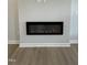Close-up of the modern fireplace with sleek black frame in the living room at 304 White Oak Garden Way # 214, Garner, NC 27529