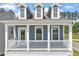 Welcoming front porch featuring white railings and columns, providing a cozy outdoor space at 304 White Oak Garden Way # 214, Garner, NC 27529