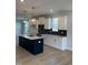 Stylish kitchen featuring a large island, white cabinets, and eye-catching backsplash at 304 White Oak Garden Way # 214, Garner, NC 27529