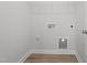 Bright laundry room with light wood floor, hookups, and wire shelving storage at 304 White Oak Garden Way # 214, Garner, NC 27529