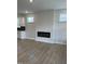 Bright living space with wood flooring, a modern fireplace, and windows for natural light at 304 White Oak Garden Way # 214, Garner, NC 27529