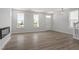 Sun-filled living space with wood floors, large windows, and a modern fireplace, perfect for gatherings at 304 White Oak Garden Way # 214, Garner, NC 27529
