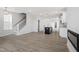 Bright and spacious living area featuring modern wood floors, a staircase, and an open layout at 304 White Oak Garden Way # 214, Garner, NC 27529