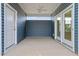 Covered outdoor patio with gray siding, fan and access to the house through a glass door at 304 White Oak Garden Way # 214, Garner, NC 27529