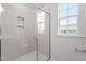 Modern shower boasting glass doors, tile walls, and built-in niche at 304 White Oak Garden Way # 214, Garner, NC 27529