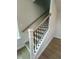 A close-up of staircase shows black railing and light wood floor, illuminated by natural light at 304 White Oak Garden Way # 214, Garner, NC 27529