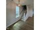 Bright stairway with wood treads and black metal spindles, illuminated by a modern light fixture at 304 White Oak Garden Way # 214, Garner, NC 27529