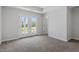 Bedroom features plush carpeting and double doors leading to a balcony at 308 White Oak Garden Way # 215, Garner, NC 27529