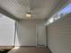 A covered patio with a ceiling fan and a white door that leads to the backyard at 308 White Oak Garden Way # 215, Garner, NC 27529