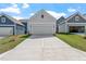 New construction home featuring a two-car garage, concrete driveway and a manicured lawn at 308 White Oak Garden Way # 215, Garner, NC 27529