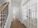 Inviting foyer with hardwood floors, staircase, and elegant French doors leading to a home office at 308 White Oak Garden Way # 215, Garner, NC 27529