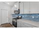 Modern kitchen with stainless steel appliances, quartz countertops, and stylish tile backsplash and fixtures at 308 White Oak Garden Way # 215, Garner, NC 27529