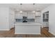 Bright kitchen featuring a central island, modern appliances, stylish backsplash, and an open-concept layout at 308 White Oak Garden Way # 215, Garner, NC 27529