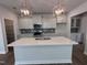 Modern kitchen features a large island, stainless appliances, and stylish pendant lighting at 308 White Oak Garden Way # 215, Garner, NC 27529