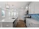 Modern kitchen with stainless steel appliances, center island, and stylish backsplash, perfect for cooking at 308 White Oak Garden Way # 215, Garner, NC 27529
