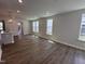 A spacious living room features wood floors, recessed lighting, and several windows for natural light at 308 White Oak Garden Way # 215, Garner, NC 27529