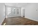 Well-lit open living space featuring hardwood floors and multiple windows at 308 White Oak Garden Way # 215, Garner, NC 27529