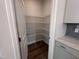 A pantry with white wire shelving and wood floors is conveniently located off the kitchen at 308 White Oak Garden Way # 215, Garner, NC 27529
