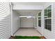 Cozy covered patio with white columns, a ceiling fan, and double doors leading indoors at 308 White Oak Garden Way # 215, Garner, NC 27529