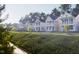A row of new construction homes showcasing their charming exterior and inviting front porches at 308 White Oak Garden Way # 215, Garner, NC 27529