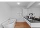 Modern bathroom featuring a soaking tub and double vanity with sleek countertops at 312 N Buchanan Blvd # 302, Durham, NC 27701