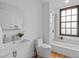 Bathroom featuring a modern sink, toilet, and shower-tub combo with marble tile at 312 N Buchanan Blvd # 302, Durham, NC 27701