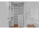 Walk-in closet features custom shelves and drawers, adjoins bathroom at 312 N Buchanan Blvd # 302, Durham, NC 27701