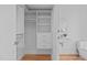 Walk-in closet with custom shelving and storage options leading to a bathroom at 312 N Buchanan Blvd # 302, Durham, NC 27701