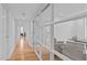 Bright hallway with hardwood floors and glass paneled office at 312 N Buchanan Blvd # 302, Durham, NC 27701
