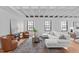 Spacious living room with hardwood floors, a sectional couch, leather chairs, and large windows at 312 N Buchanan Blvd # 302, Durham, NC 27701