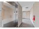Hallway featuring elevator with tiled floor and block walls with exit sign at 312 N Buchanan Blvd # 302, Durham, NC 27701