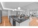 Open-concept kitchen with pendant lighting, an island with bar stools, and views into the living area at 312 N Buchanan Blvd # 302, Durham, NC 27701