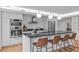 Modern kitchen with stainless steel appliances, a center island with seating, and sleek white cabinets at 312 N Buchanan Blvd # 302, Durham, NC 27701
