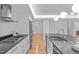 A modern kitchen with white cabinets, a stainless steel fridge, and a kitchen island at 312 N Buchanan Blvd # 302, Durham, NC 27701
