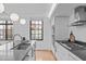 Well-lit kitchen with stainless steel appliances, white cabinets, island, and a window above sink at 312 N Buchanan Blvd # 302, Durham, NC 27701