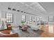 Bright living room featuring hardwood floors, exposed beams, and multiple windows for plenty of natural light at 312 N Buchanan Blvd # 302, Durham, NC 27701