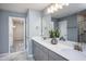 Bathroom with a double vanity, quartz countertop and a separate walk-in closet at 3412 Pelican Ln, Durham, NC 27703
