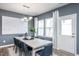 Elegant dining room with modern lighting, neutral decor, and a view of the backyard at 3412 Pelican Ln, Durham, NC 27703