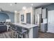 Stylish kitchen with gray cabinets, stainless steel refrigerator, and a quartz-topped island at 3412 Pelican Ln, Durham, NC 27703
