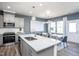 Modern kitchen with stainless steel appliances, a central island, and stylish pendant lighting at 3412 Pelican Ln, Durham, NC 27703