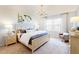 Inviting bedroom featuring a large bed, soft lighting, neutral colors, and ample natural light at 345 Broomside Ave, Raleigh, NC 27603