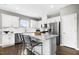 A modern kitchen boasts stainless steel appliances, white cabinetry, an island, and bar stool seating at 345 Broomside Ave, Raleigh, NC 27603
