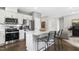 Modern kitchen features stainless steel appliances, white cabinets, and an island with bar stool seating at 345 Broomside Ave, Raleigh, NC 27603
