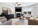 Cozy living room with a fireplace, mounted tv, hardwood floors and large windows at 345 Broomside Ave, Raleigh, NC 27603