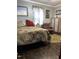Cozy bedroom showcasing bed, area rug, curtains, natural light, and hardwood floors at 3607 Buffaloe Rd, Raleigh, NC 27604