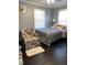 Inviting bedroom features a comfy bed, a floral chair, and natural light at 3607 Buffaloe Rd, Raleigh, NC 27604